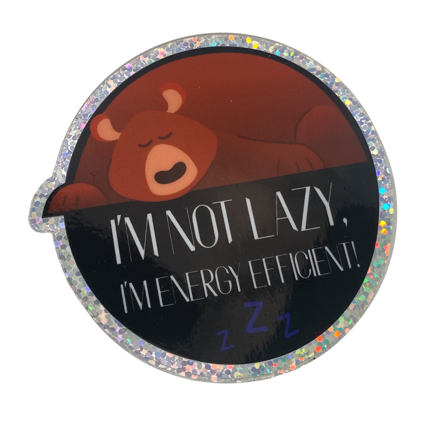 A round sticker with a brown bear image and the text 'I'm Not Lazy, I'm Energy Efficient.' with a sparkle background.
