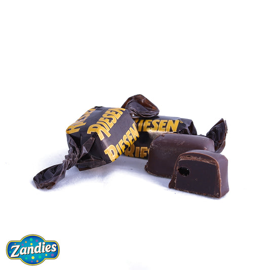 Photo of Riesen candy, in the wrapper, out of the wrapper, and cut in half to show the inside texture. Zandies logo in the corner.