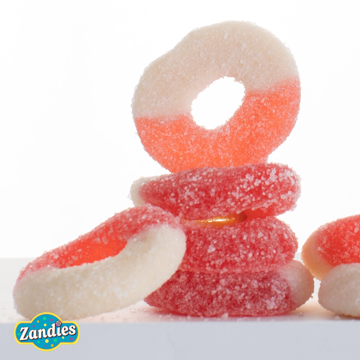 Stack of red and white gummy candies with Zandies logo on a white background