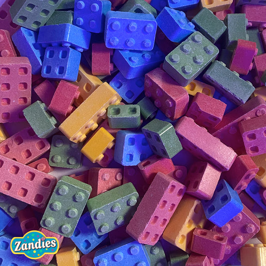 Bulk pile of Candy Blox hard candy blocks in assorted colors, block-shaped novelty candy