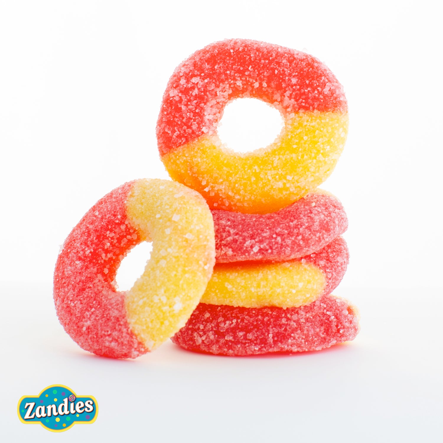 Stack of red and yellow gummi peach  rings with Zandies logo on a white background