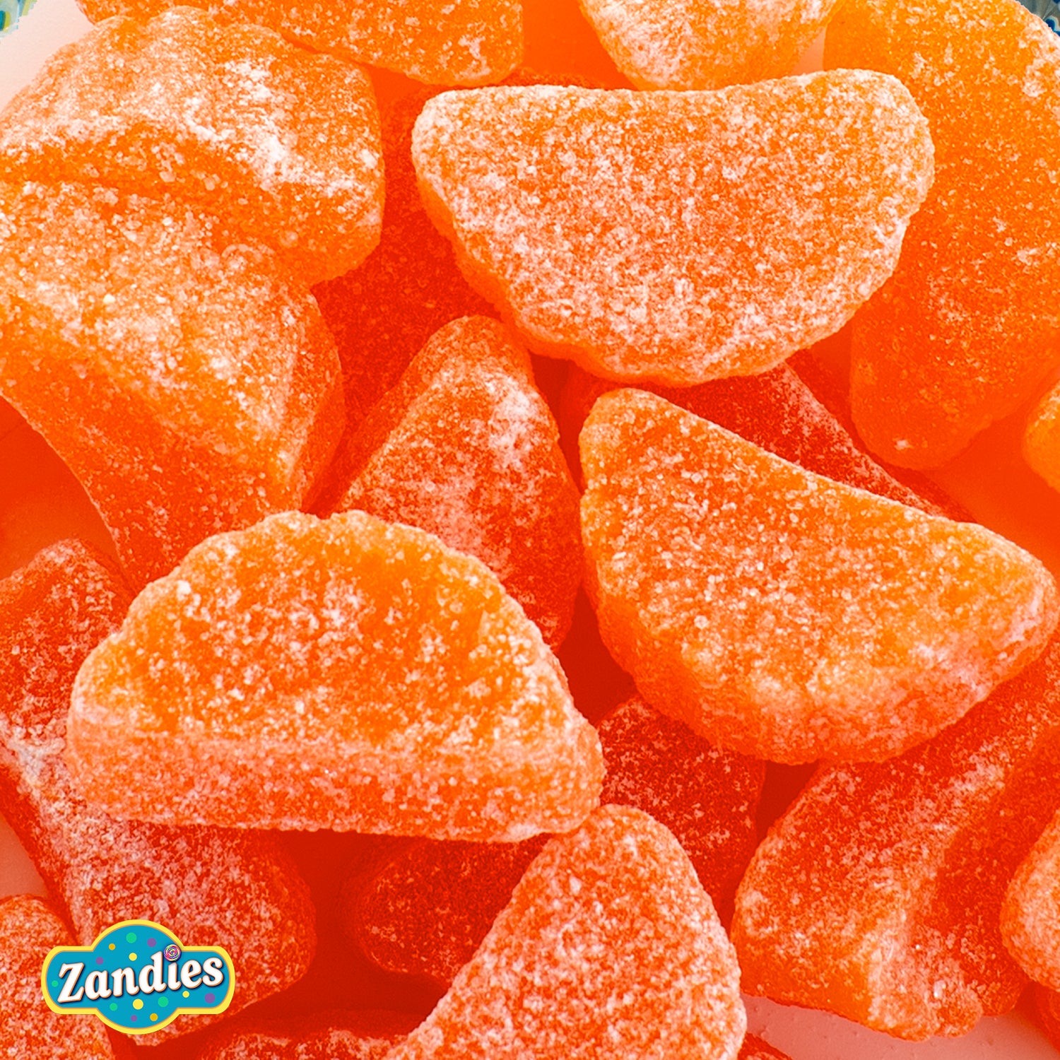 Individual gummy orange slice candies shaped like citrus wedges